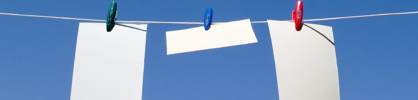 Image of white paper pinned to a clothes line