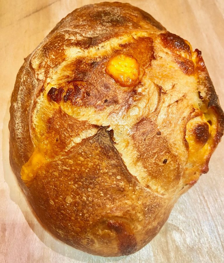 Picture of a light brown loaf infused with evaporated belgian-style wheat ale and cheddar cheese